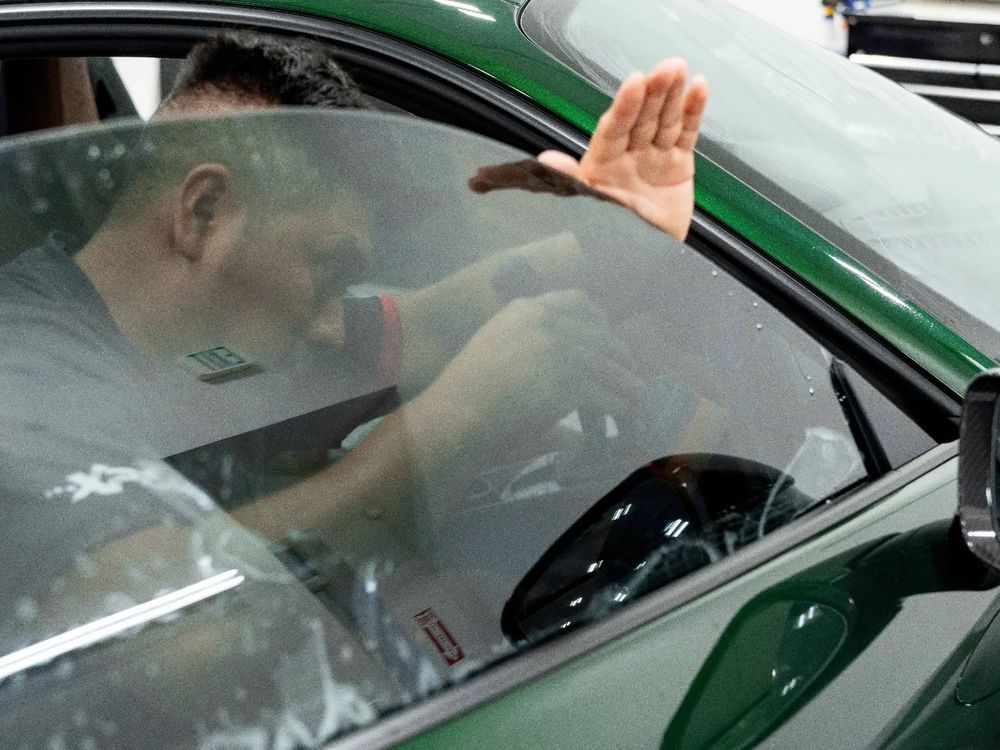 Ceramic window tint being fitted to a green Porsche 911